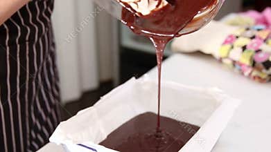 Making Chocolate Brownie Cake. Pouring Melting Chocolate