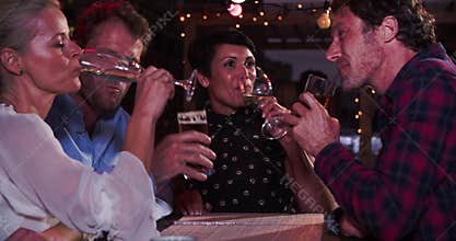 Group Of Mature Friends Relaxing Together At Rooftop Bar
