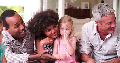 Group Of Families At Home On Patio Talking Together