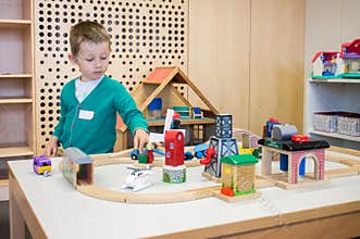 Kindergarten boy playing with toys