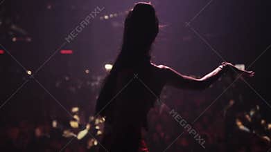 Go go girl dancing on background of crowd