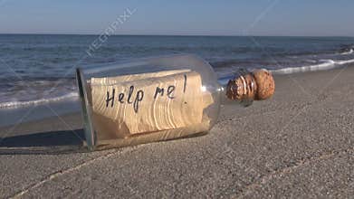Seascape with bottle with message â€œhelp meâ€ in sand