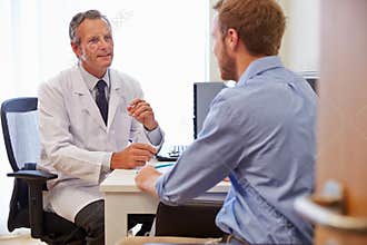 Male Patient Having Consultation With Doctor In Office