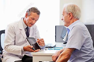Senior Patient Having Consultation With Doctor In Office
