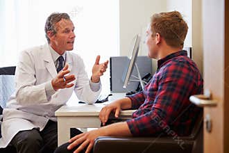 Patient Having Consultation With Male Doctor In Office