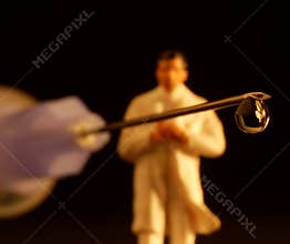 Syringe with drop and figurine