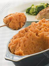 Dish of Sweet Potato Mash with a spoon