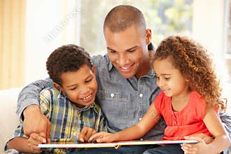 Father reading to children