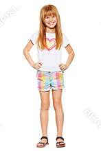 Full length a cheerful little girl with red hair in shorts and a T-shirt; isolated on the white