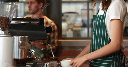 Smiling barista serving a client
