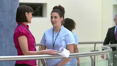Consultant Meeting With Nurse In Hospital Reception