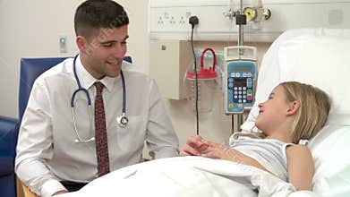 Doctor Talking With Young Girl In Hospital Bed