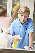 Unhappy Children Helping to Clean House