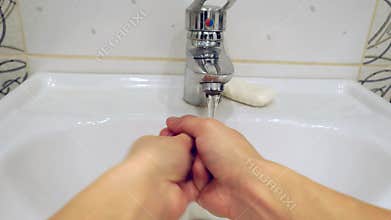 Washing of hands with soap under running water