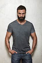 Bearded brutal guy wearing blank grey t-shirt