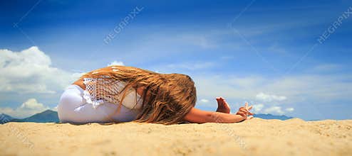 girl in lace sits in yoga asana head-to-knee forward bend