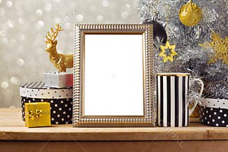 Christmas poster mock up template with Christmas tree and gift boxes. Black, golden and silver decorations