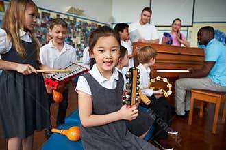 Group Of Children Playing In School Orchestra Together