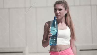 Fitness Woman drinking water on location