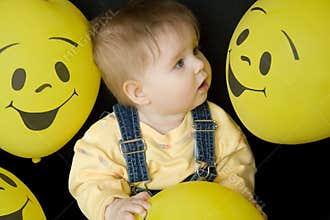 Baby looking at balloons