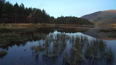Beautiful footage of still lake and mountains against sky