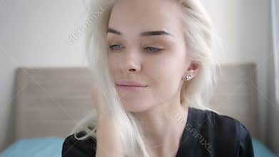 Closeup Beautiful Young Blond Woman Waking up and Stretching on the Bed at Home