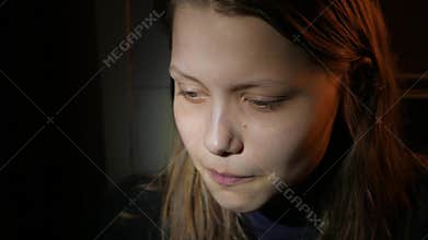 Young teen girl in the dark, UHD 4K