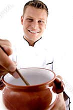 Smart chef cooking in porcelain pot