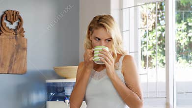 Blonde woman drinking a cup of coffee