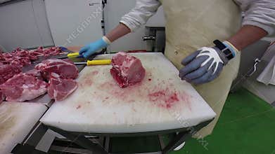 Butcher Cutting Raw Meat With Cleaver in Slaughterhouse