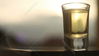 Potent alcoholic beverage being poured into glass