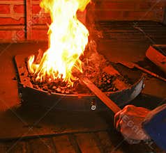 Hot iron in a forge with fire