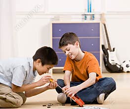 Boy helping friend fix broken toy