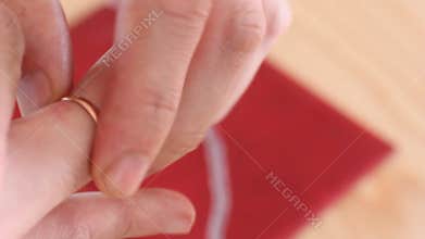 The man removes his wedding ring