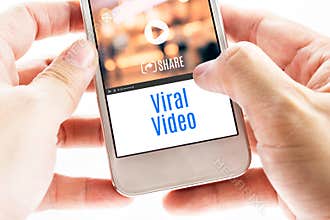 Close up Two hand holding smart phone with Viral Video word and