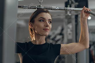 Young girl in the gym performing exercises