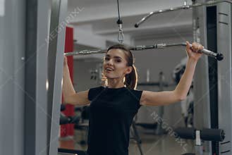Young girl in the gym performing exercises