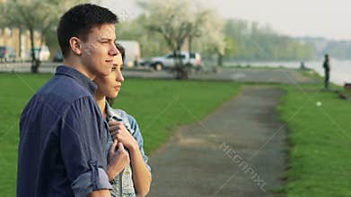 Couple standing on the path near the sea and looking. Slowly