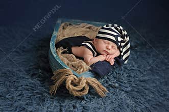 Newborn Baby Boy Sleeping in a Boat