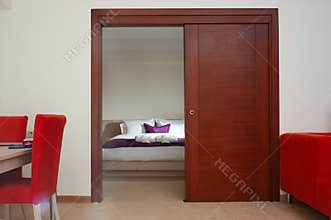 Cozy Bedroom View Through Elegant Wooden Sliding Door