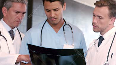 Doctors talking together while looking X-ray