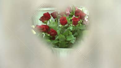 A bouquet of red roses through the heart