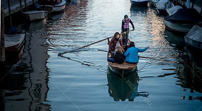 Girls on boat on Venetian canal