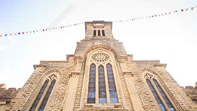 Camera Approaches Front Wall at Backlight of Catholic Church