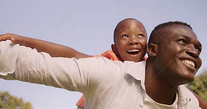 Man carrying his son on his back
