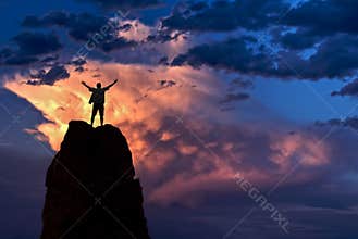 Man with arms raised in the sky winner success concept