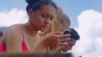 Afro woman looking at smartphone outdoor. African girl using phone