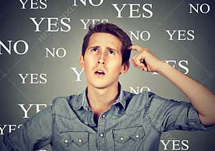 Thinking perplexed man with yes or no choice looking up