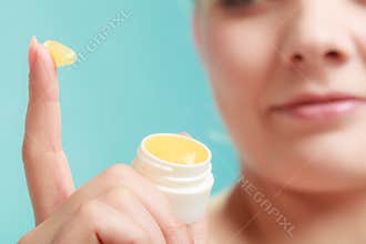 Woman applying balsam for lips