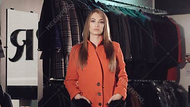 Rich lady catwalking in red fur coats in the rich boutique. Slowly